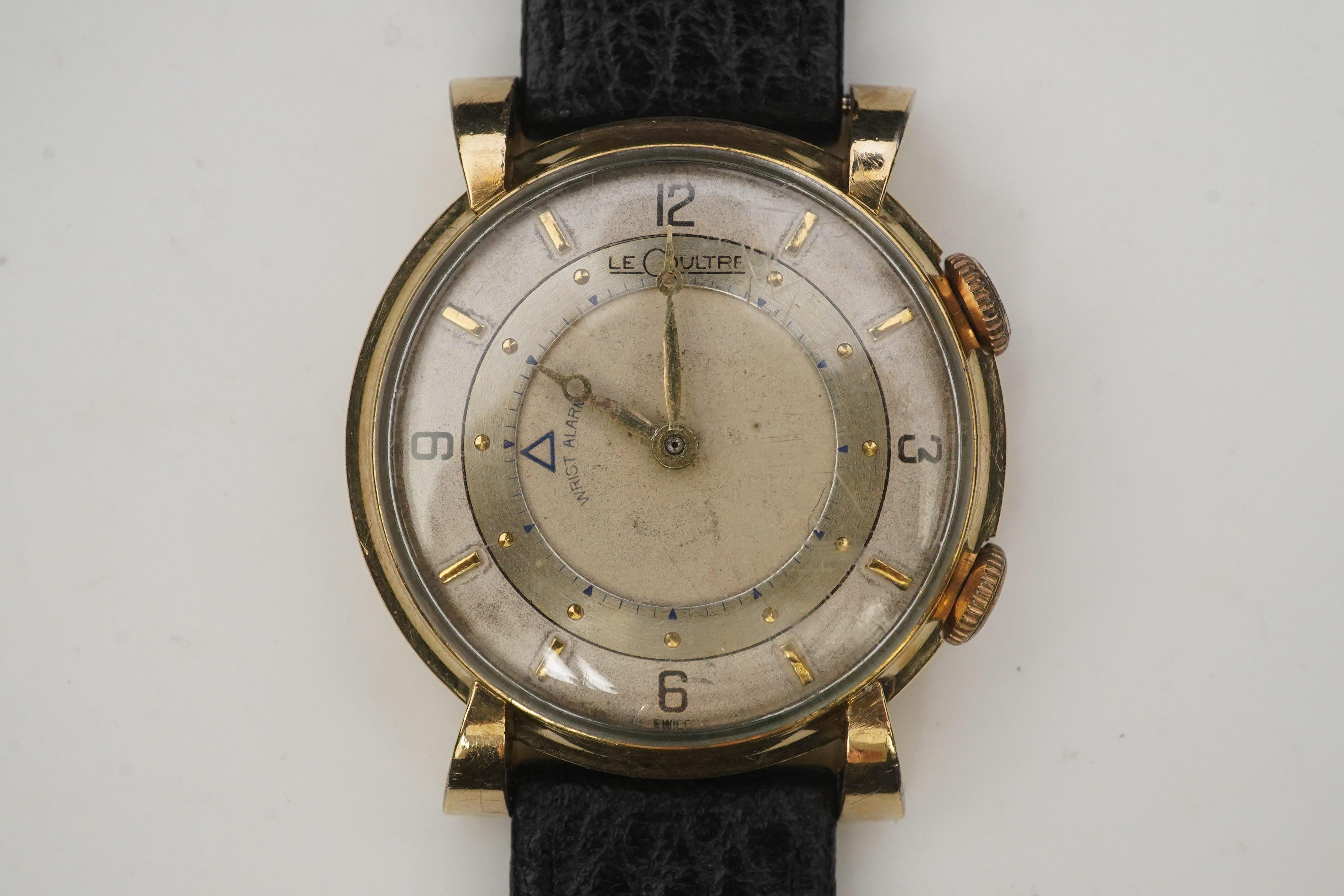 A gentleman's 1950's? 10k gold filled Jaeger LeCoultre Memovox manual wind wrist watch, on a later associated leather strap